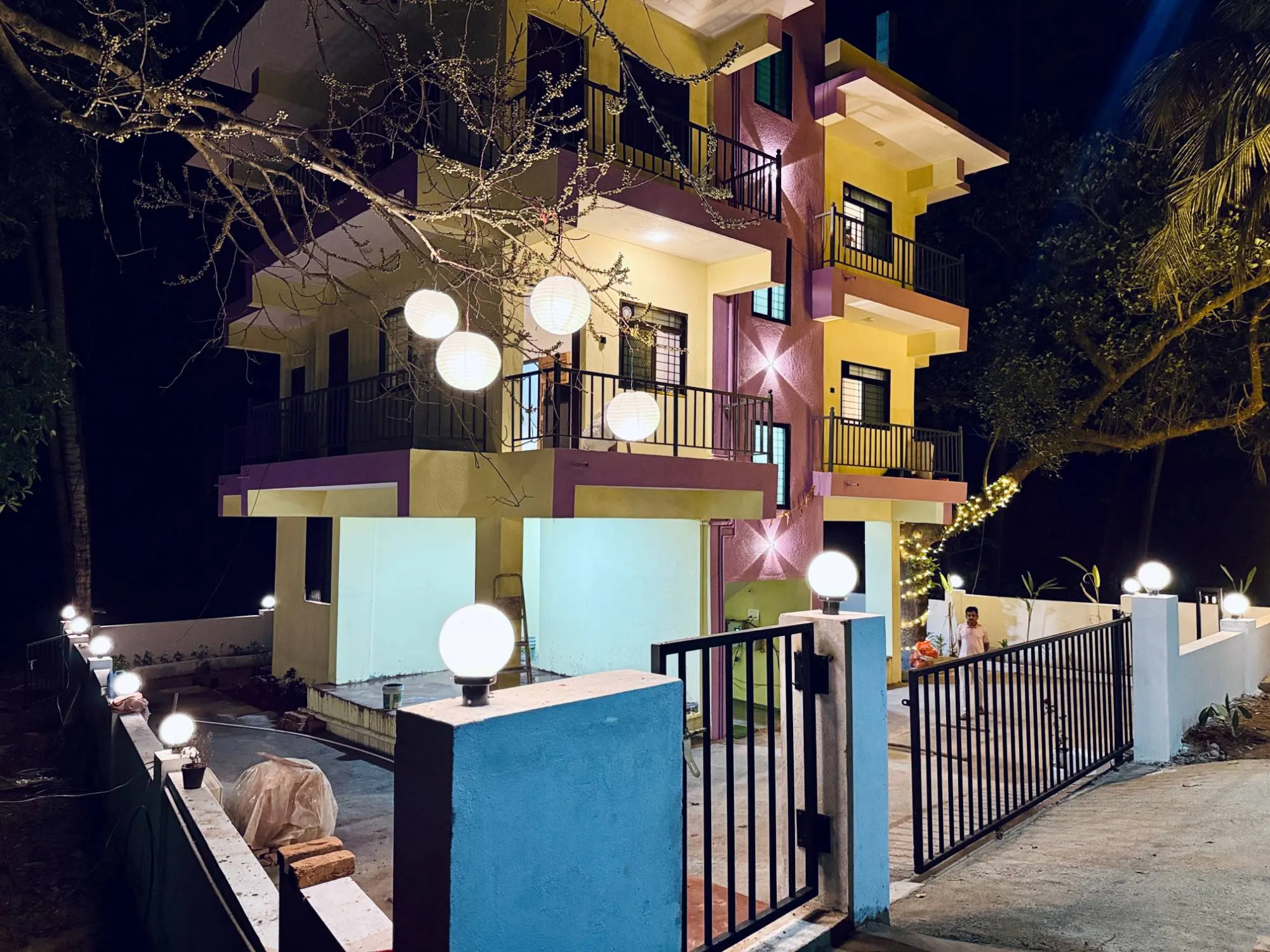 Sadanand Guest House entrance gate and building at night