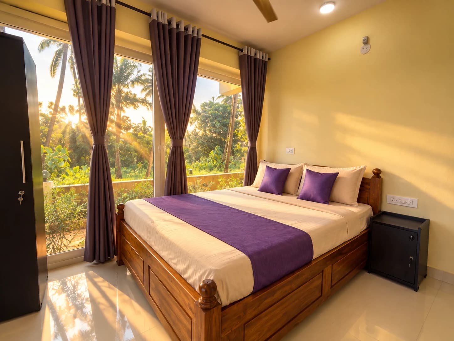 Deluxe Queen Room with queen bed and large windows overlooking palm trees